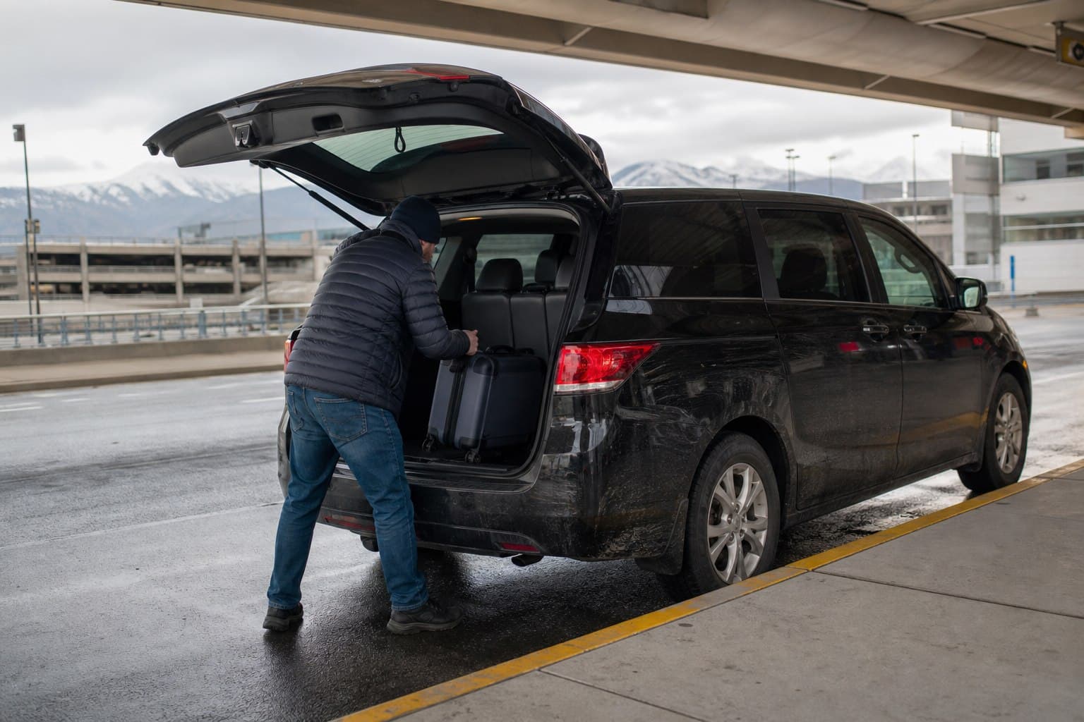 Traveler loading luggage into a private transfer vehicle in Alaska