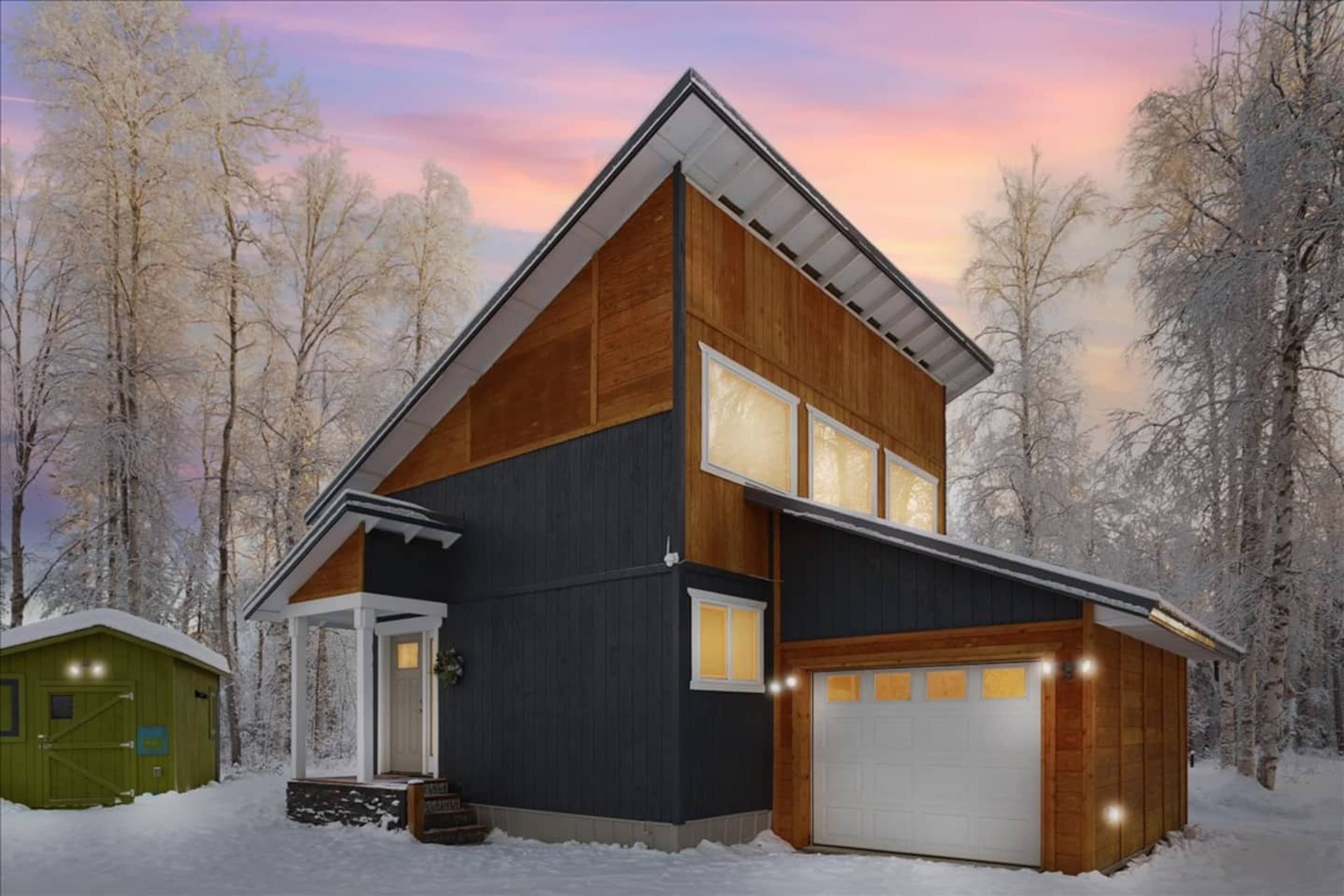 Caswell Cabin surrounded by snowy Alaska woodland